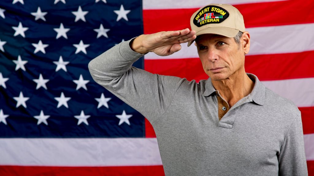 Gulf War Veteran Saluting in Front of American Flag