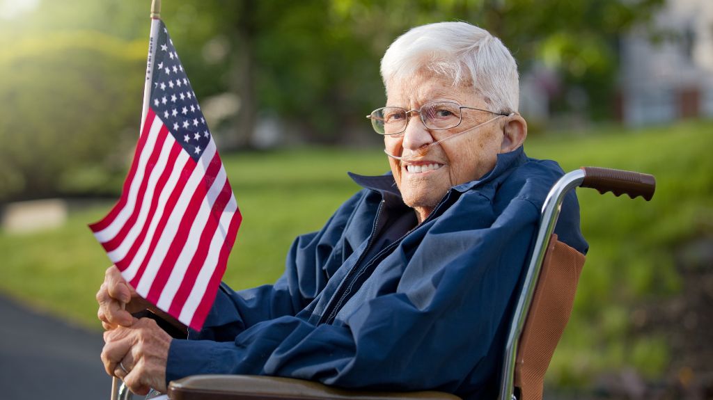 Veteran in a Wheelchair with American Flag and Oxygen Nose Cane