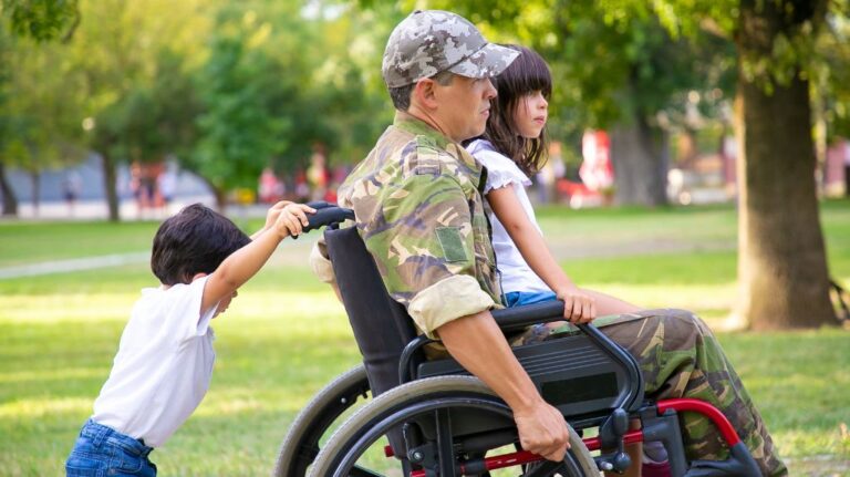 Child Pushing Veteran in a Wheelchair