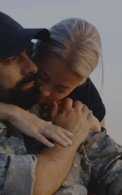 a woman hugging a soldier