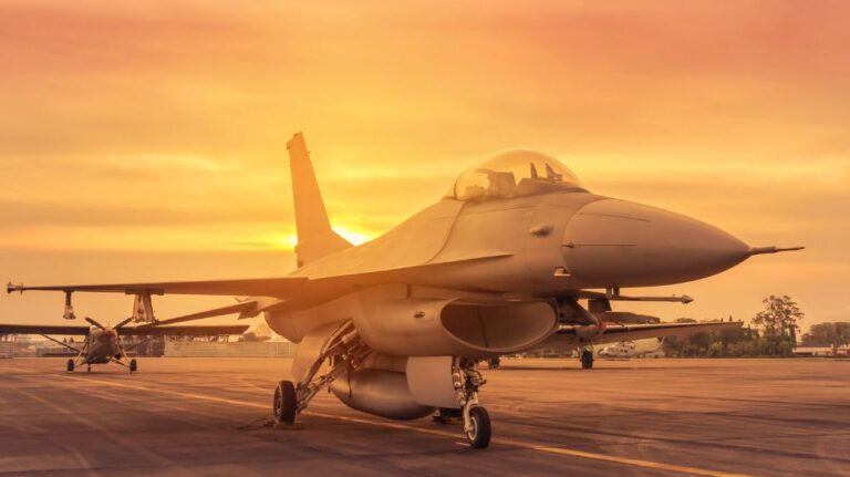 Fighter Jet on Runway of Military Base at Sunrise