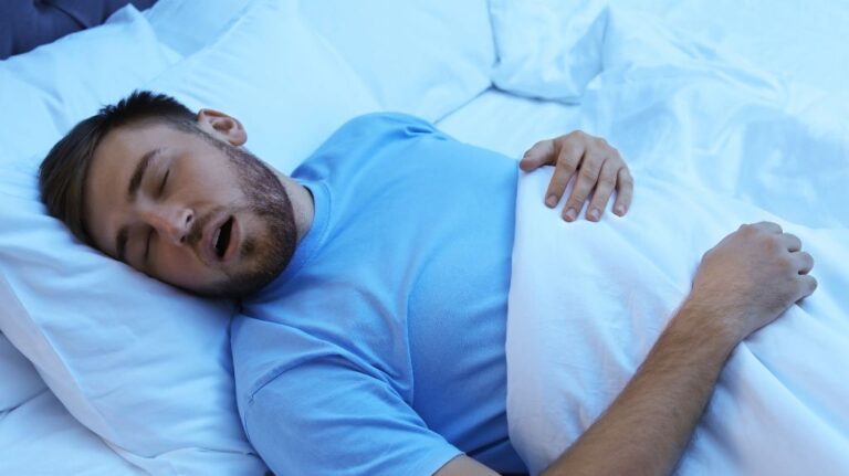 Man in Bed Snoring with Sleep Apnea