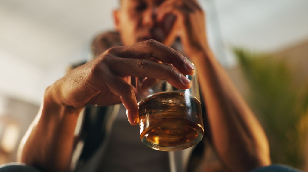 Man Holding a Glass of Whiskey