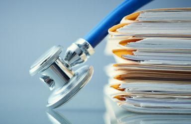 Pile of Medical Documents with a Stethoscope