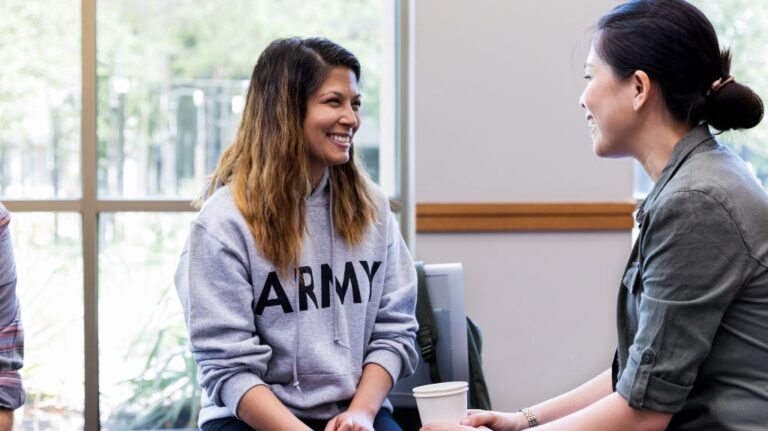 Woman in Army Sweatshirt Talking to Medical Professional