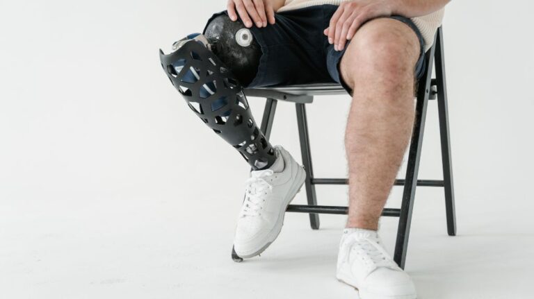 Man Sitting in Chair with Prosthetic Leg