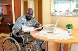 Veteran in Wheelchair Looking at Documents