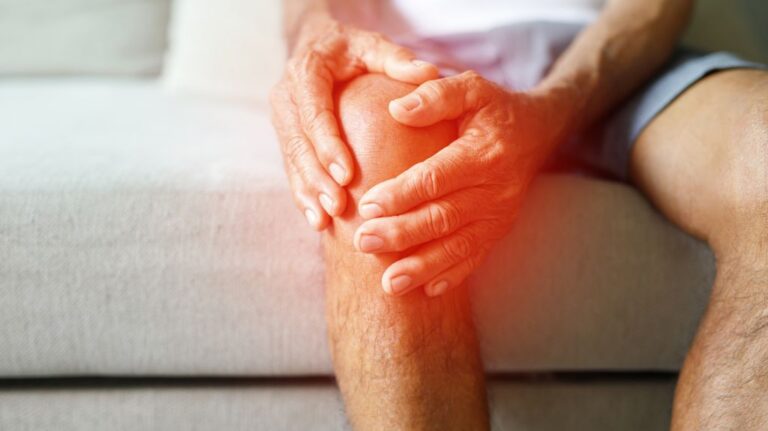Man Holding Knee with Red Pain Indicator