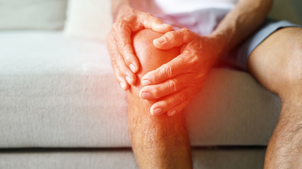 Man Holding Knee with Red Pain Indicator