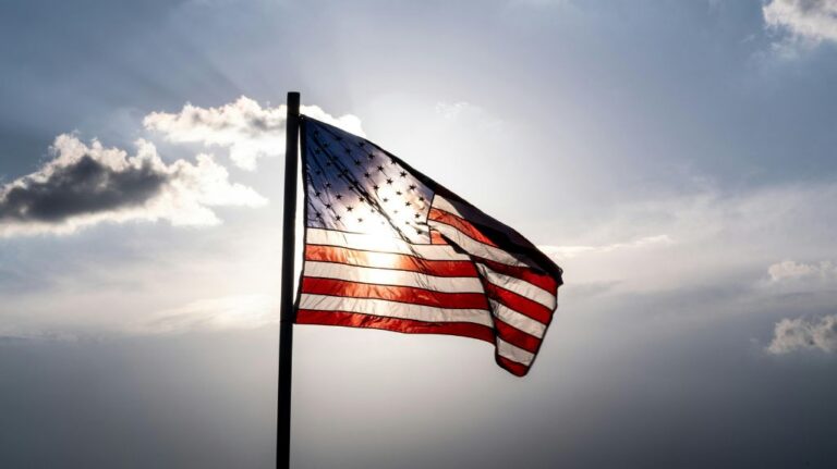 American Flag with Sun Behind It