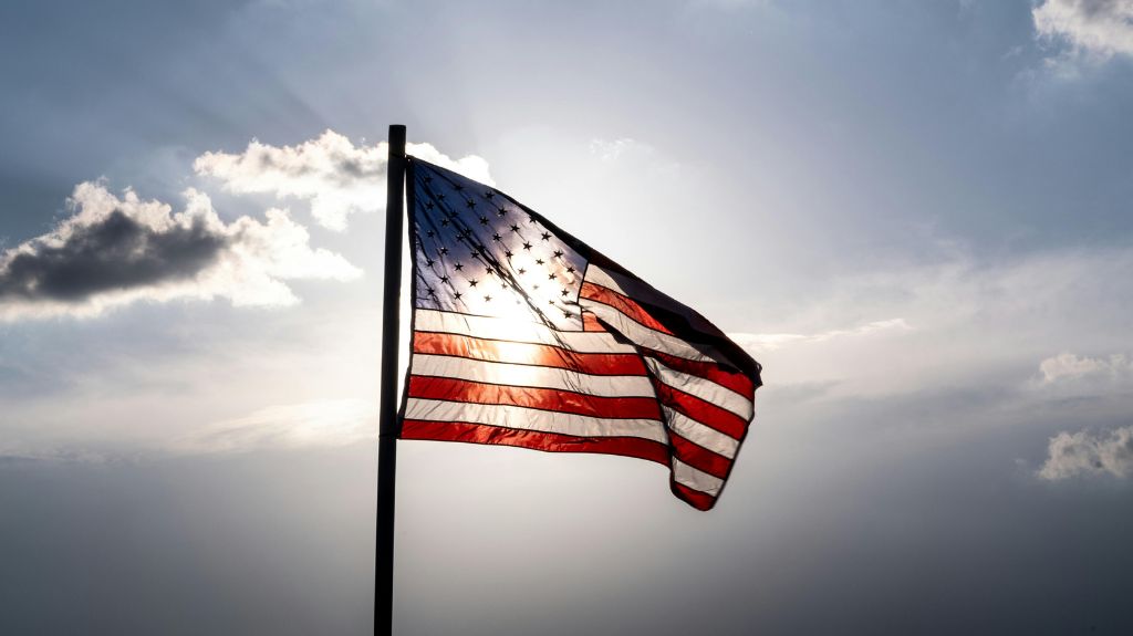 American Flag with Sun Behind It