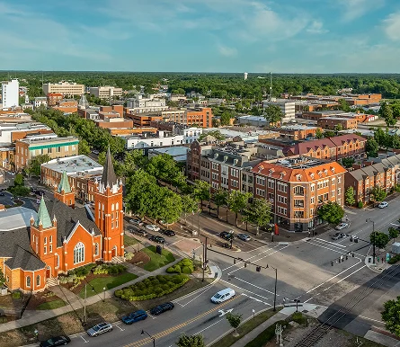 Fayetteville cityscape featuring a church and several buildings against a clear sky