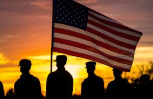 Soldiers Standing with American Flag at Sunset