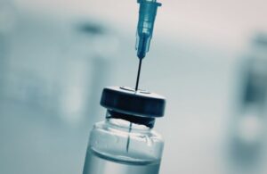 Syringe Getting Medication from a Bottle