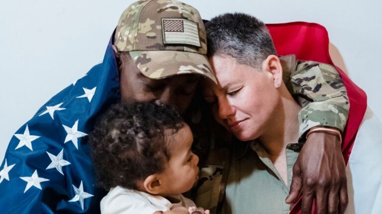 Veteran Wrapped in Flag Hugging Family
