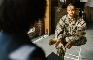 Marine in Camo Speaking with Therapist