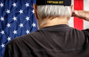 Back of Veteran's Head Facing American Flag and Saluting