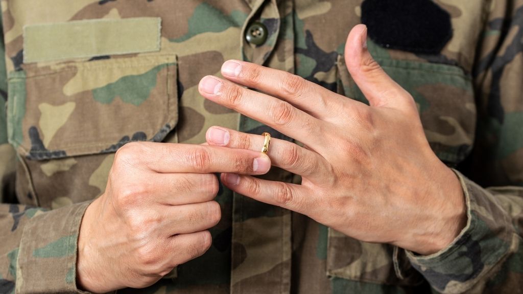 Veteran in Camo Fatigues Taking Wedding Ring Off