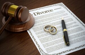 Divorce Documents, Gavel, and Wedding Rings on a Table