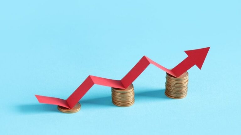 Blue Background with Red Up Arrow on Piles of Coins
